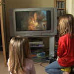 Two of the children who took part in the experiment watching TV before the ban. ©BBC